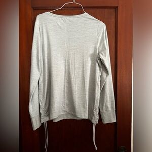 Woman’s long sleeve tee, pull strings on either side giving a little unique look